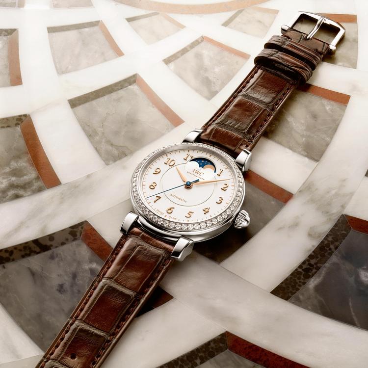 The white dial fake watch has a brown strap.